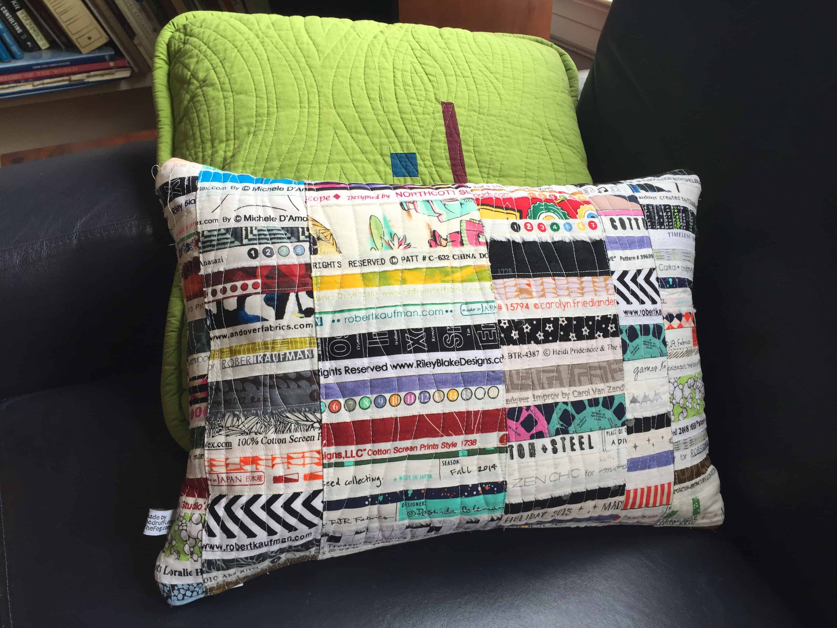 New covers for the living room pillows - using up those selvage scraps!